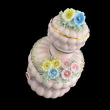Load image into Gallery viewer, Vintage mid-century pink double pointed ceramic vanity perfume bottle featuring figural flowers and gold spaghetti. Made in Japan. As pretty addition to any bath or bedroom vanity!

In excellent condition, no chips. Marked Japan.

Measures 3 1/4 x 5 1/2
