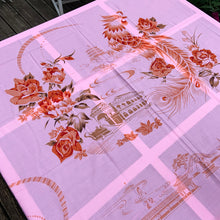 Load image into Gallery viewer, We are suckers for gorgeous linens and this piece does not disappoint! This strikingly unique vintage Barbie pink linen tablecloth features a printed pattern of roses and Chinoiserie river scenes and pagodas in shades of orange, brown and ochre . A conversation piece for your table!~  This piece is new old stock and does not appear to have been used to laundered and is in excellent condition.  Measures 52 x 85 inches   
