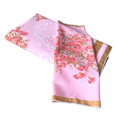 Give your table a touch of elegance with this vintage pink cotton tablecloth featuring flowers in eye-popping salmon with swirls of pale pink, bordered in ochre. With 12 matching napkins. Perfect for adding a hint of sophistication to any gathering! In excellent condition, free from stains/tears Tablecloth measures 56 x 92 inches Napkin measures 16 1/2 x 17 inches