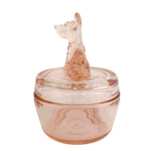 Load image into Gallery viewer, Vintage Jeannette Glass pink depression glass powder jar with lid, right side profile view, showing the seated Scottie dog finial in profile with upturned snout, textured fur moulding on body, flat lid with concentric ring detail, rounded barrel base
