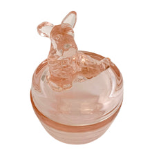 Load image into Gallery viewer, Vintage Jeannette Glass pink depression glass powder jar with lid, three-quarter front view from slightly above, showing the Scottie dog finial facing left with pointed ears and textured body, flat lid, rounded base in blush pink glass
