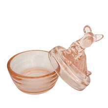 Load image into Gallery viewer, Vintage Jeannette Glass pink depression glass powder jar, open view, lid removed and leaning upright beside the open base, showing the hollow interior of the ribbed rounded base and the underside of the flat domed lid with seated terrier dog finial,
