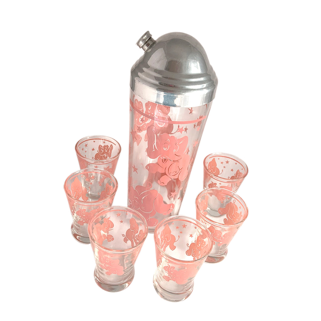 Delightful vintage Pink Elephant cocktail shaker with chrome ribbed dome lid and six whiskey glasses decorated with playful pink elephants. Crafted by Hazel-Atlas Glass, USA, 1940s/1950s. This highly collectible and whimsical barware will add a ton of fun to your cocktail party!

In excellent condition, no chips.

Shaker measures 3 5/8 x 9 7/8 inches

Glasses measure 2 3/8 x 3 1/4 inches