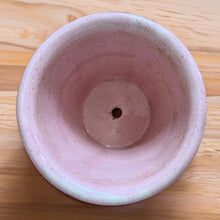 Load image into Gallery viewer, Vintage pink art pottery planter pot featuring a ribbed design and attached underplate. Crafted by McCoy Pottery, USA, circa 1940s. A collectible art pottery planter is perfect for a tiny houseplant, succulents or as part of your McCoy collection!  In vintage condition, several chips a crack. See photos for details.  Measures 4 1/8 x 3 1/2 inches
