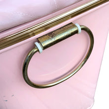 Load image into Gallery viewer, Gold-tone metal trim and hardware detail on vintage mid-century pink hamper showing minor corrosion
