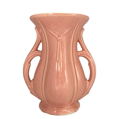 Beautiful vintage gloss pink ribbed trumpet vase with handles and embossed tassel. Crafted by McCoy Pottery, 1940s. This vase is must for any art pottery collector!

In excellent vintage condition, no chips/cracks/repairs, with age-related crazing. Maker's mark on the bottom.

Measures 6 x 4 3/8 x 8 1/4 inches