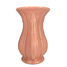 Load image into Gallery viewer, Beautiful vintage gloss pink ribbed trumpet vase with handles and embossed tassel. Crafted by McCoy Pottery, 1940s. This vase is must for any art pottery collector!

In excellent vintage condition, no chips/cracks/repairs, with age-related crazing. Maker&#39;s mark on the bottom.

Measures 6 x 4 3/8 x 8 1/4 inches
