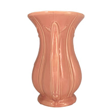 Load image into Gallery viewer, Beautiful vintage gloss pink ribbed trumpet vase with handles and embossed tassel. Crafted by McCoy Pottery, 1940s. This vase is must for any art pottery collector!

In excellent vintage condition, no chips/cracks/repairs, with age-related crazing. Maker&#39;s mark on the bottom.

Measures 6 x 4 3/8 x 8 1/4 inches

