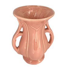 Load image into Gallery viewer, Beautiful vintage gloss pink ribbed trumpet vase with handles and embossed tassel. Crafted by McCoy Pottery, 1940s. This vase is must for any art pottery collector!

In excellent vintage condition, no chips/cracks/repairs, with age-related crazing. Maker&#39;s mark on the bottom.

Measures 6 x 4 3/8 x 8 1/4 inches
