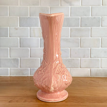 Load image into Gallery viewer, Beautiful vintage Art Deco pink pitcher vase features a unique handle and embossed grapevines. Crafted by McCoy Pottery, 1946. This vase is must for any art pottery collector. A lovely way to enhance your home&#39;s decor or to give as a gift!

In excellent vintage condition, no chips/cracks/repairs. Typical manufacturer&#39;s glaze misses/pops. Maker&#39;s mark on the bottom.

Measures 5 x 9 1/4 inches (incl. handle/spout)
