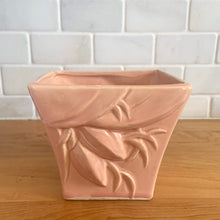 Load image into Gallery viewer, Vintage gloss pink glazed lily bud jardiniere planter No. 39. Crafted by McCoy Pottery, USA, 1948. This collectible planter is the perfect for succulents or decorative display and makes a lovely gift for an art pottery collector.

In excellent vintage condition, no chips, cracks or repairs, manufacturer's glaze pops. Makers mark.

Measures 4 5/8 x 4 1/8 x 4 inches
