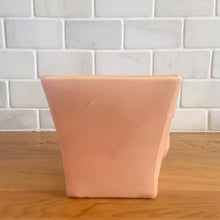 Load image into Gallery viewer, Vintage gloss pink glazed lily bud jardiniere planter No. 39. Crafted by McCoy Pottery, USA, 1948. This collectible planter is the perfect for succulents or decorative display and makes a lovely gift for an art pottery collector.

In excellent vintage condition, no chips, cracks or repairs, manufacturer's glaze pops. Makers mark.

Measures 4 5/8 x 4 1/8 x 4 inches
