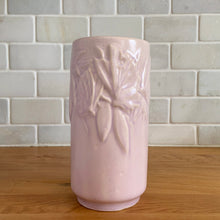 Load image into Gallery viewer, Vintage Art Deco matte pink Butterfly Line cylinder vase. Crafted by Nelson McCoy Pottery, early 1940s. This rare piece is must for any art pottery collector! A lovely way to enhance your home&#39;s decor or give as a gift!

In excellent vintage condition, no chips/cracks/repairs. Typical age-related crazing, manufacturer&#39;s glaze pops. Maker&#39;s marks.

Measures 3 x 6 inches

