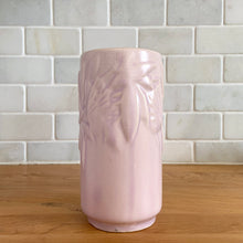 Load image into Gallery viewer, Vintage Art Deco matte pink Butterfly Line cylinder vase. Crafted by Nelson McCoy Pottery, early 1940s. This rare piece is must for any art pottery collector! A lovely way to enhance your home&#39;s decor or give as a gift!

In excellent vintage condition, no chips/cracks/repairs. Typical age-related crazing, manufacturer&#39;s glaze pops. Maker&#39;s marks.

Measures 3 x 6 inches
