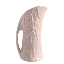 Load image into Gallery viewer, Beautiful vintage Butterfly Line vase glazed in matte lilac, features embossed butterflies and strap handle. Crafted by Nelson McCoy Pottery, early 1940s. This rare pitcher is must for any art pottery collector!

In good vintage condition, no chips, no cracks, no repairs, crazing commensurate with age and manufacturer&#39;s defects. Impressed NM USA mark on the bottom.

Measures 6 x 4 1/2 x 10 1/4 inches
