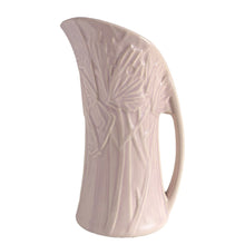 Load image into Gallery viewer, Beautiful vintage Butterfly Line vase glazed in matte lilac, features embossed butterflies and strap handle. Crafted by Nelson McCoy Pottery, early 1940s. This rare pitcher is must for any art pottery collector!

In good vintage condition, no chips, no cracks, no repairs, crazing commensurate with age and manufacturer&#39;s defects. Impressed NM USA mark on the bottom.

Measures 6 x 4 1/2 x 10 1/4 inches
