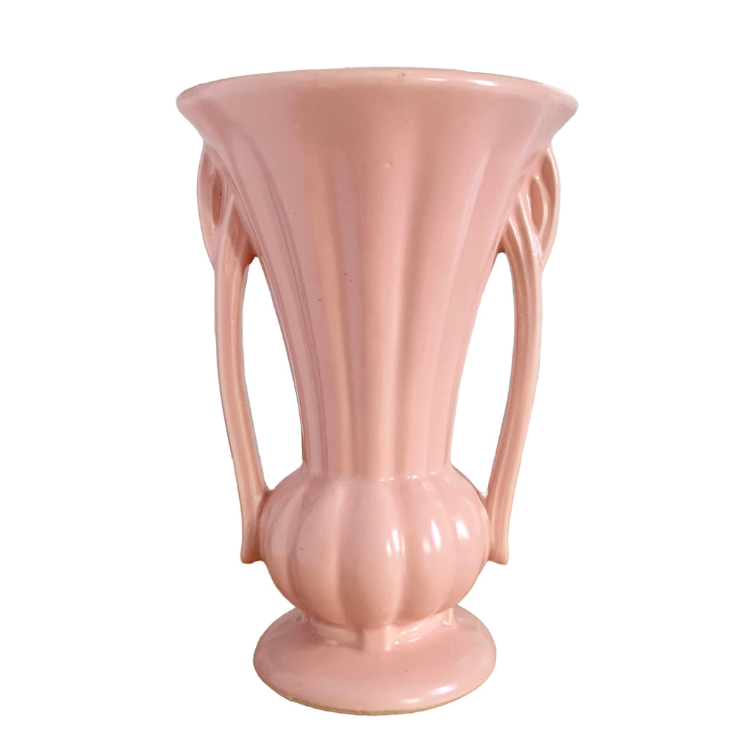 Beautiful vintage matte pink classically shaped handled trumpet vase. Crafted by McCoy Pottery, 1940s. This vase is must for any art pottery collector!

In as found vintage condition, no chips or repairs, tight hairline crack. Maker's mark on the bottom.

Measures 6 1/4 x 9 1/4 inches