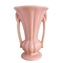 Load image into Gallery viewer, Beautiful vintage matte pink classically shaped handled trumpet vase. Crafted by McCoy Pottery, 1940s. This vase is must for any art pottery collector!

In as found vintage condition, no chips or repairs, tight hairline crack. Maker&#39;s mark on the bottom.

Measures 6 1/4 x 9 1/4 inches
