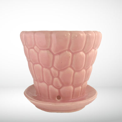 Striking vintage gloss pink pebble planter pot with attached saucer. Crafted by McCoy Pottery, 1950s. This planter is must for any McCoy art pottery collector!

In excellent vintage condition, no chips or cracks, crazing present. Marked 303 and 6 on the bottom.

Measures 6 1/4 x 5 1/2 inches