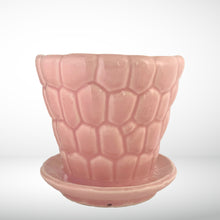 Load image into Gallery viewer, Striking vintage gloss pink pebble planter pot with attached saucer. Crafted by McCoy Pottery, 1950s. This planter is must for any McCoy art pottery collector!

In excellent vintage condition, no chips or cracks, crazing present. Marked 303 and 6 on the bottom.

Measures 6 1/4 x 5 1/2 inches
