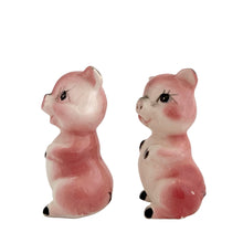 Load image into Gallery viewer, Pair of vintage mid-century era hand painted pink pig ceramic figurines. Made in Japan. An adorable addition to any kitsch decor collection!

In as found vintage condition. One pig has a chip on ear tip.

Measures 2 1/2 inches tall
