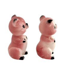 Load image into Gallery viewer, Pair of vintage mid-century era hand painted pink pig ceramic figurines. Made in Japan. An adorable addition to any kitsch decor collection!

In as found vintage condition. One pig has a chip on ear tip.

Measures 2 1/2 inches tall
