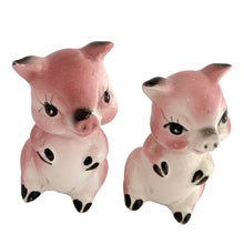 Load image into Gallery viewer, Pair of vintage mid-century era hand painted pink pig ceramic figurines. Made in Japan. An adorable addition to any kitsch decor collection!

In as found vintage condition. One pig has a chip on ear tip.

Measures 2 1/2 inches tall
