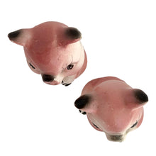 Load image into Gallery viewer, Pair of vintage mid-century era hand painted pink pig ceramic figurines. Made in Japan. An adorable addition to any kitsch decor collection!

In as found vintage condition. One pig has a chip on ear tip.

Measures 2 1/2 inches tall
