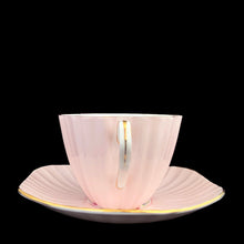 Load image into Gallery viewer, Handle view of vintage EB Foley 1850 scalloped bone china teacup and saucer, pale pink with floral motif and gold gilt
