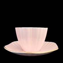 Load image into Gallery viewer, Back view of vintage EB Foley 1850 scalloped bone china teacup and saucer, pale pink with floral motif and gold gilt
