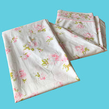 Load image into Gallery viewer, Vintage Truprest pink Rose Romance queen size flat poly/cotton white bed sheet featuring roses in shades of pink and green, trimmed with pink lace at the band. Crafted by Texmade, Canada, 1973-1977. A beautiful addition to your bedding collection, or repurpose for crafts, quilting or garment making.

In excellent vintage condition, no stains or tears, fading. Original label present.

Measures 88 x 106 inches | 224 x 270 centimeters.
