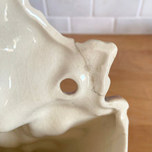 Load image into Gallery viewer, Rare vintage mid-century gloss pink tint magnolia vase with green leaves. Crafted by McCoy Pottery, USA, 1953. This special piece is must for any art pottery collector!

In as found used vintage condition. This vase has several cracks and a repair. Still displays well. Maker&#39;s mark.

Measures 7 x 3 1/2 x 8 1/4 inches
