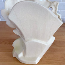 Load image into Gallery viewer, Rare vintage mid-century gloss pink tint magnolia vase with green leaves. Crafted by McCoy Pottery, USA, 1953. This special piece is must for any art pottery collector!

In as found used vintage condition. This vase has several cracks and a repair. Still displays well. Maker&#39;s mark.

Measures 7 x 3 1/2 x 8 1/4 inches
