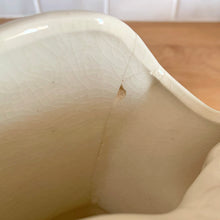 Load image into Gallery viewer, Rare vintage mid-century gloss pink tint magnolia vase with green leaves. Crafted by McCoy Pottery, USA, 1953. This special piece is must for any art pottery collector!

In as found used vintage condition. This vase has several cracks and a repair. Still displays well. Maker&#39;s mark.

Measures 7 x 3 1/2 x 8 1/4 inches
