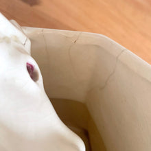 Load image into Gallery viewer, Rare vintage mid-century gloss pink tint magnolia vase with green leaves. Crafted by McCoy Pottery, USA, 1953. This special piece is must for any art pottery collector!

In as found used vintage condition. This vase has several cracks and a repair. Still displays well. Maker&#39;s mark.

Measures 7 x 3 1/2 x 8 1/4 inches
