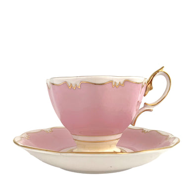 This vintage bone china footed teacup and saucer is so sweet! This teacup and saucer in the Malvern shape are hand painted in pink and pale yellow with a stylized gold git border. Produced by Royal Albert, England, circa 1960s. A lovely addition to your tableware or collection.  In excellent condition, no chips/cracks/repairs. Maker's marks on each piece. Teacup measures 3 1/2 x 2 5/8 inches. Saucer measures 5 1/2 inches