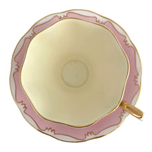 Load image into Gallery viewer, This vintage bone china footed teacup and saucer is so sweet! This teacup and saucer in the Malvern shape are hand painted in pink and pale yellow with a stylized gold git border. Produced by Royal Albert, England, circa 1960s. A lovely addition to your tableware or collection.  In excellent condition, no chips/cracks/repairs. Maker&#39;s marks on each piece. Teacup measures 3 1/2 x 2 5/8 inches. Saucer measures 5 1/2 inches
