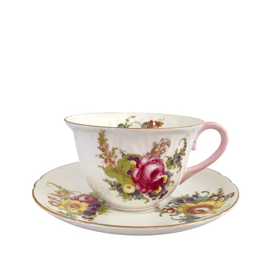 Vintage white bone china Oleander shaped teacup and saucer, featuring pink and yellow cabbage roses along with country flowers, trimmed with gold gilt. Crafted by Shelley, England, 1938 - 1966. Makes a beautiful gift or addition to your collection!
