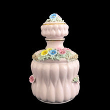 Load image into Gallery viewer, Vintage mid-century pink double pointed ceramic vanity perfume bottle featuring figural flowers and gold spaghetti. Made in Japan. As pretty addition to any bath or bedroom vanity!

In excellent condition, no chips. Marked Japan.

Measures 3 1/4 x 5 1/2
