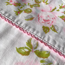 Load image into Gallery viewer, Vintage Truprest pink Rose Romance queen size flat poly/cotton white bed sheet featuring roses in shades of pink and green, trimmed with pink lace at the band. Crafted by Texmade, Canada, 1973-1977. A beautiful addition to your bedding collection, or repurpose for crafts, quilting or garment making.

In excellent vintage condition, no stains or tears, fading. Original label present.

Measures 88 x 106 inches | 224 x 270 centimeters.
