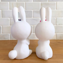 Load image into Gallery viewer, Adorable kitschy pink and blue bunny rabbit couple Bun-Bun chalkware figurines with the sweetest expressions and flower details. Crafted in Taiwan, 1970s. New old stock in original box. Cute doesn&#39;t quite capture these sweethearts!

In excellent condition, new in original shipping box.

Measures approximately 2 5/8 x 2 7/8 x 6 3/4 inches
