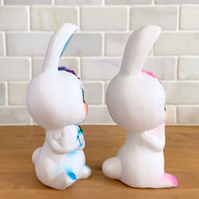 Load image into Gallery viewer, Adorable kitschy pink and blue bunny rabbit couple Bun-Bun chalkware figurines with the sweetest expressions and flower details. Crafted in Taiwan, 1970s. New old stock in original box. Cute doesn&#39;t quite capture these sweethearts!

In excellent condition, new in original shipping box.

Measures approximately 2 5/8 x 2 7/8 x 6 3/4 inches
