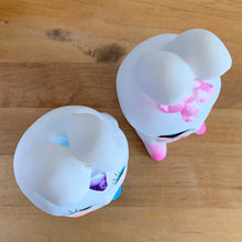 Load image into Gallery viewer, Adorable kitschy pink and blue bunny rabbit couple Bun-Bun chalkware figurines with the sweetest expressions and flower details. Crafted in Taiwan, 1970s. New old stock in original box. Cute doesn&#39;t quite capture these sweethearts!

In excellent condition, new in original shipping box.

Measures approximately 2 5/8 x 2 7/8 x 6 3/4 inches

