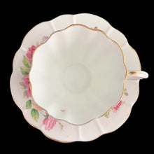 Load image into Gallery viewer, This vintage bone china scalloped shaped teacup and saucer featuring pink roses and gold gilt details. Crafted by Royal Stuart, England, 1948 - 1960. A lovely way to enjoy a cuppa tea.

In excellent condition, no chips, cracks or repairs. Maker&#39;s mark on the bottom.

Teacup measures 3 1/2 x 2 3/4 inches | Saucer measures 5 7/8 inches
