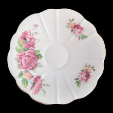 Load image into Gallery viewer, This vintage bone china scalloped shaped teacup and saucer featuring pink roses and gold gilt details. Crafted by Royal Stuart, England, 1948 - 1960. A lovely way to enjoy a cuppa tea.

In excellent condition, no chips, cracks or repairs. Maker&#39;s mark on the bottom.

Teacup measures 3 1/2 x 2 3/4 inches | Saucer measures 5 7/8 inches
