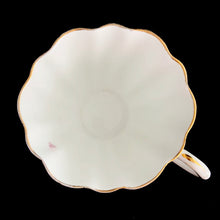 Load image into Gallery viewer, This vintage bone china scalloped shaped teacup and saucer featuring pink roses and gold gilt details. Crafted by Royal Stuart, England, 1948 - 1960. A lovely way to enjoy a cuppa tea.

In excellent condition, no chips, cracks or repairs. Maker&#39;s mark on the bottom.

Teacup measures 3 1/2 x 2 3/4 inches | Saucer measures 5 7/8 inches
