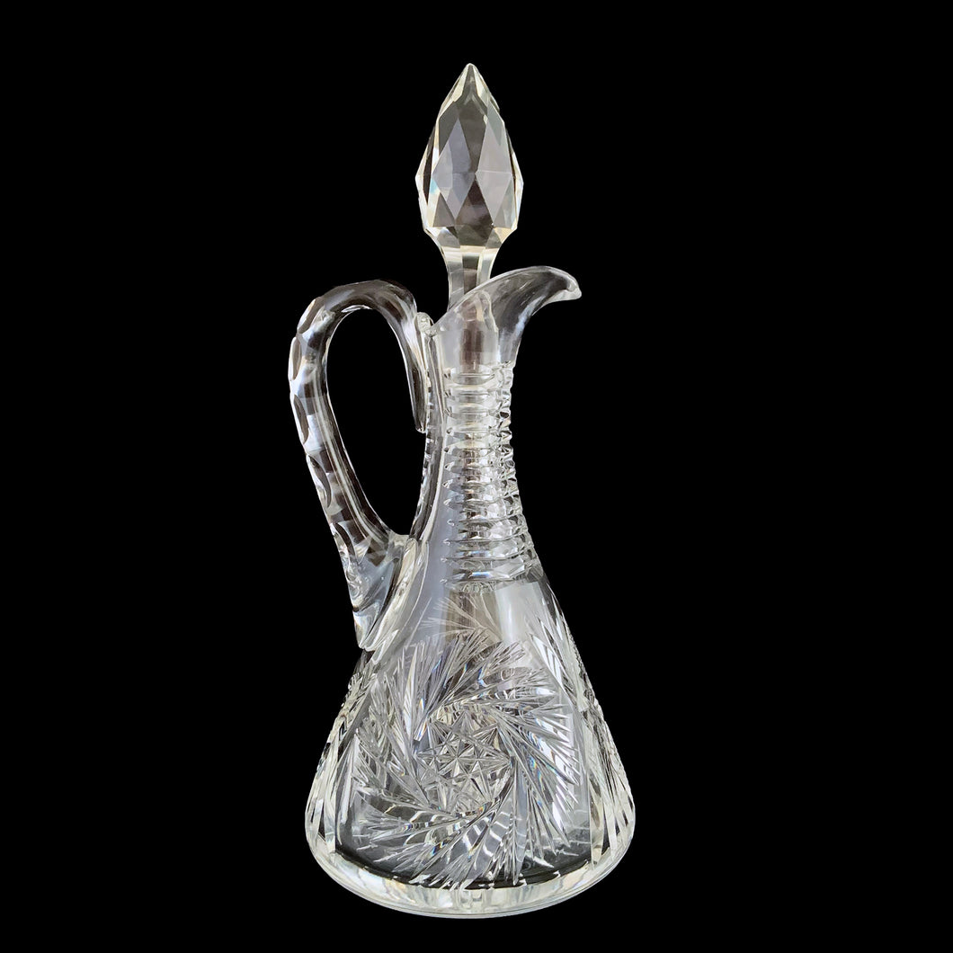 Add a touch of elegance to your tablescape with this antique vintage American Brilliant cut crystal cruet featuring a stunning pinwheel design with faceted stopper and handle. Crafted in the USA, early 20th century. Bring a little sparkle to your home with this lovely cruet.

In excellent condition, no chips.

Measures 3 1/2 x 8 inches