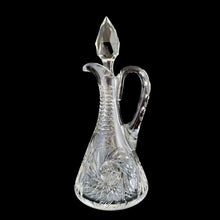 Load image into Gallery viewer, Add a touch of elegance to your tablescape with this antique vintage American Brilliant cut crystal cruet featuring a stunning pinwheel design with faceted stopper and handle. Crafted in the USA, early 20th century. Bring a little sparkle to your home with this lovely cruet.

In excellent condition, no chips.

Measures 3 1/2 x 8 inches
