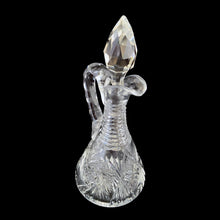 Load image into Gallery viewer, Add a touch of elegance to your tablescape with this antique vintage American Brilliant cut crystal cruet featuring a stunning pinwheel design with faceted stopper and handle. Crafted in the USA, early 20th century. Bring a little sparkle to your home with this lovely cruet.

In excellent condition, no chips.

Measures 3 1/2 x 8 inches
