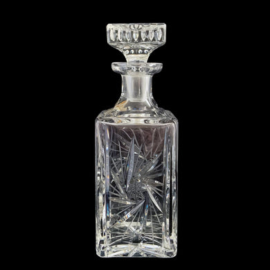 Vintage cut crystal liquor square decanter featuring a pattern of pinwheels and starbursts. Crafted in Germany, circa 1950s. Add this eye catching crystal to your bar cart!

In excellent condition, no chips. Minor wear to the stopper's end. Original sticker.

Measures 3 x 3 x 8 3/4 inches

Capacity 1 pint or 500ml